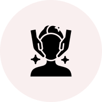 Group 4 Icon of hands around a person's head with sparkles, representing face care or beauty treatment, on a pink circular background.
