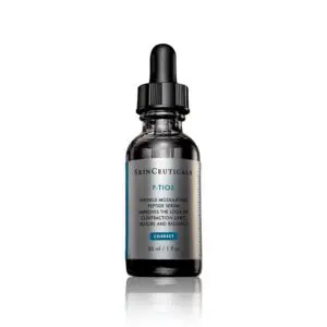 A dropper bottle of facial serum with a reflective label.