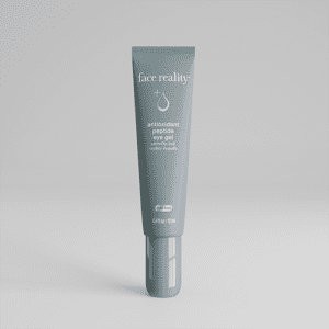 A gray tube of skincare cream on a plain gray background.