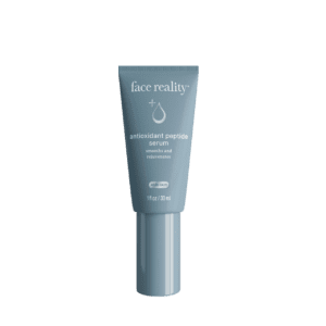 A gray tube of face reality skincare product with a nozzle tip.