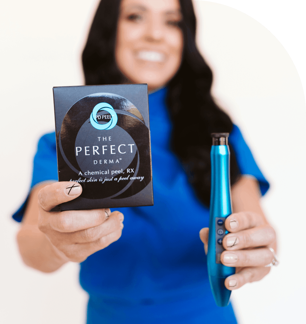 Group 1321317370 A person in blue holds a box labeled "The Perfect Derma" and a blue skincare device, smiling.